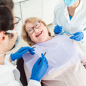 Patient smiling at dentist sitting in treatment chair